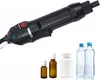 A handheld electric sealing machine is shown above several bottles, including two water bottles, a white pill bottle, and two small amber glass bottles. Podgląd zdjęcia produktu