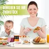 A mother and child are enjoying breakfast together, with jars of jam and bread on the table. Produktbild-Vorschau