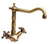 A bronze-colored kitchen faucet with two cross-shaped handles. Anteprima dell’immagine prodotto