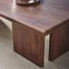 Close-up of a wooden coffee table with a rounded edge, showing the wood grain and texture. Produktbild-Vorschau