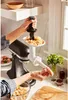 A person is using a KitchenAid stand mixer with a meat grinder attachment to make sausages. Anteprima dell’immagine prodotto