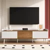 A modern TV stand with a television mounted above it, in a well-lit room. Náhled obrázku produktu