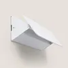 A white LED wall light mounted on a light gray wall. Produktbild-Vorschau