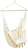 A beige hammock chair with orange and yellow tassels hanging from a wooden bar. Produktbild-Vorschau