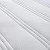A close-up view of a white mattress surface with quilted lines. Voir les images du produit