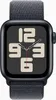 A close-up front view of a smartwatch with a dark grey sport loop band and a dark grey watch face displaying large, light beige numbers. Voir les images du produit