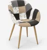 A patchwork chair with wooden legs on a white background. Voir les images du produit