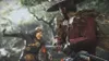 Two samurai warriors in a forest setting, one in the foreground facing away from the camera, the other in the background facing the camera. Produktbild-Vorschau
