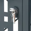 A close-up of a lock and key on a dark gray metal surface with a patterned cutout. Náhľad obrázku produktu