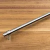 A silver cabinet handle on a wooden surface. Produktbild-Vorschau