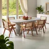 A dining room scene with an oval table and chairs, set near a large window with a view of greenery and a pool. Produktbild-Vorschau