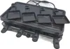 A black electric raclette grill with four small grilling pans. Voir les images du produit