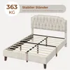A beige upholstered bed frame with a tufted headboard and wooden slats, shown from a diagonal front view. Text overlays highlight its stability and weight capacity. Produktbild-Vorschau