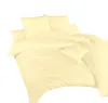 A neatly folded set of yellow bedding, including a duvet cover and pillows, is displayed against a white background. Podgląd zdjęcia produktu
