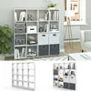 A white modular bookshelf filled with various items, including books, storage boxes, and decorative objects. The bookshelf is placed in a room with gray walls and a white and gray patterned rug. Náhled obrázku produktu