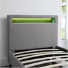 Close-up of a grey upholstered bed frame with integrated green LED lighting in the headboard. Produktbild-Vorschau