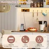 A kitchen counter with a kettle, fruit bowl, and a charging station with a phone. Anteprima dell’immagine prodotto