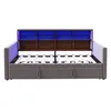 A grey upholstered daybed with a wooden headboard featuring built-in shelves and blue LED lighting. Voir les images du produit