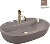 A beige oval washbasin with a gold faucet. Náhled obrázku produktu