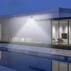 A modern house with a swimming pool at dusk, illuminated by a solar-powered outdoor light. Produktbild-Vorschau