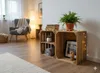 A living room scene with wooden crates used as shelving, displaying decorative items. Produktbild-Vorschau