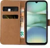 A brown leather flip case for a smartphone, with a credit card and euro banknotes inserted into the case. Produktbild-Vorschau