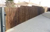 A bamboo fence along a driveway with a house in the background. Produktbild-Vorschau