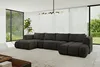 A spacious, modern living room with large windows overlooking a garden, featuring a large U-shaped sectional sofa. Produktbild-Vorschau