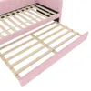 A close-up view of a pink daybed with its pull-out trundle bed extended, showing the wooden slat support system. Podgląd zdjęcia produktu