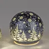 A decorative LED sphere with a Christmas tree and snowflake design. Produktbild-Vorschau