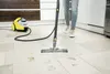 A person is using a steam cleaner on a tiled floor with muddy footprints. Anteprima dell’immagine prodotto
