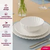 A table setting with white dishes and a vase of flowers. Náhled obrázku produktu