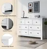 A white dresser with multiple drawers is shown in a room with framed art on the wall and a rug on the floor. Insets highlight features of the dresser. Produktbild-Vorschau