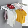 A wall-mounted drying rack with shoes and clothes hanging on it. Produktbild-Vorschau