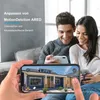 A couple is looking at a smartphone displaying a house with a grid overlay, suggesting a security camera view. Náhled obrázku produktu