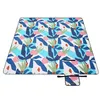 A flat lay of a picnic blanket with a colorful abstract leaf pattern. Náhled obrázku produktu