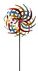 A colorful metal wind spinner on a black pole against a white background. Produktbild-Vorschau