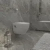 A modern bathroom with a wall-mounted toilet, marble-effect tiles, and a decorative lantern. Produktbild-Vorschau