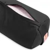 A close-up view of a black yoga bolster with a partially unzipped opening revealing a pink interior. Náhľad obrázku produktu