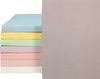 A stack of colorful fitted sheets next to a larger gray sheet. Produktbild-Vorschau