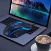 A gaming mouse is placed on a laptop keyboard, with a cup of coffee in the foreground. Produktbild-Vorschau