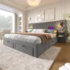 A modern bedroom with a large upholstered bed, nightstand, and a large window. Produktbild-Vorschau