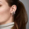 Close-up of a woman's ear wearing earrings. Produktbild-Vorschau