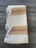 A folded fabric awning valance with striped pattern is laid on a wooden surface. Produktbild-Vorschau