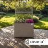 A planter with flowers and a trellis in a garden setting. Voir les images du produit