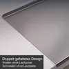 A close-up view of a stainless steel cutting board with text overlay. Produktbild-Vorschau