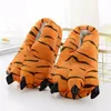 A pair of tiger paw slippers are displayed on a white surface. Náhled obrázku produktu