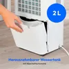 A person's hand is shown removing a water tank from a white dehumidifier. Produktbild-Vorschau