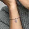 A close-up shot of a person's arm wearing a silver bracelet with a heart-shaped tree charm adorned with pink and purple stones. Produktbild-Vorschau