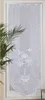 A white lace door panel with floral and bird embroidery is shown hanging in a doorway. Produktbild-Vorschau